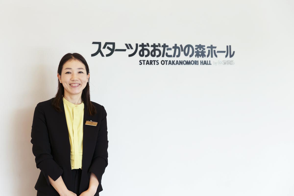 スターツおおたかの森ホール前に立つ大関さん